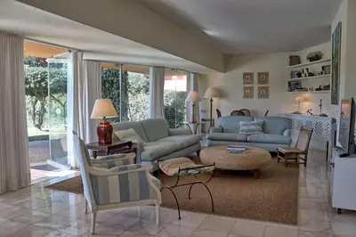 a living room with a couch and a table at Casa da Palmeira, pool & soccer pitch in Vilamoura