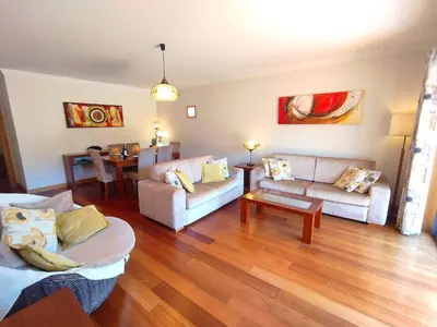 a living room with two couches and a table at Fabulous Sunny Pool&Garden Condo by BeCherish in Albufeira