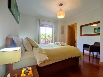 a bedroom with a bed with pillows and a window at Fabulous Sunny Pool&Garden Condo by BeCherish in Albufeira
