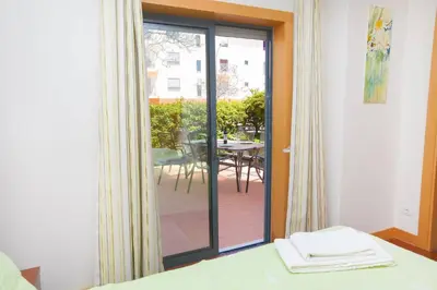 a room with a sliding glass door leading to a patio at Fabulous Sunny Pool&Garden Condo by BeCherish in Albufeira