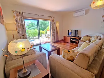 a living room with a couch and a table at Fabulous Sunny Pool&Garden Condo by BeCherish in Albufeira