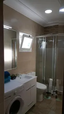 a bathroom with a sink and a shower and a toilet at Apartamento Cardoso II. A 5 minuto a pé da praia do Peneco in Albufeira