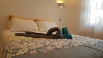 a stuffed animal is laying on a bed at Apartamento Cardoso II. A 5 minuto a pé da praia do Peneco in Albufeira