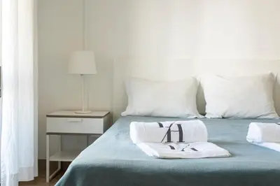a bed with two towels with the number forty on it at Sea Studio in Quarteira