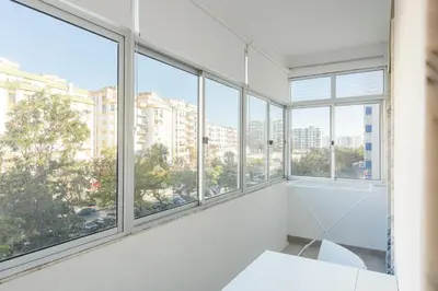 an empty room with windows in a building at Sea Studio in Quarteira