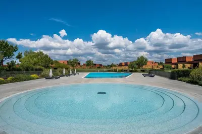 a large swimming pool in the middle of a yard at Vilamoura Charming Apartment by Intiholidays in Vilamoura