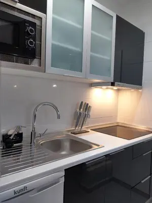 a kitchen with a sink and a microwave at Panoramic Sea View 1 Bedroom Apartment in Albufeira