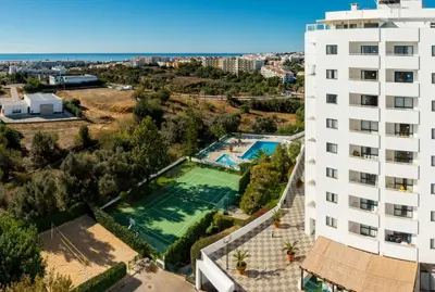 an aerial view of a building and a swimming pool at Panoramic Sea View 1 Bedroom Apartment in Albufeira