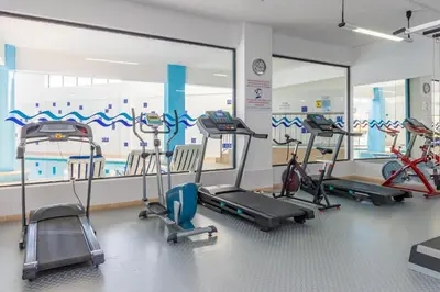 a gym with several elliptical machines in a room at Panoramic Sea View 1 Bedroom Apartment in Albufeira