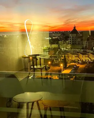 a view of a city with tables and a sunset at Edifício Algarve in Quarteira