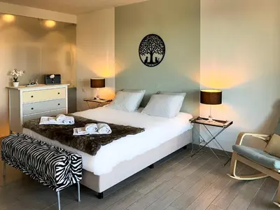a bedroom with a bed with two towels on it at Edifício Algarve in Quarteira