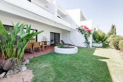 a backyard with a patio with grass and plants at Victory Village 1B Quinta do Lago in Quinta do Lago