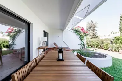 an internal view of a house with a wooden deck at Victory Village 1B Quinta do Lago in Quinta do Lago