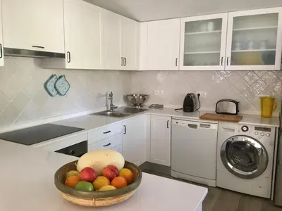a kitchen with a bowl of fruit on a counter at Villa Zen - beautiful private pool-heating option, hot tub, beautiful garden in Albufeira