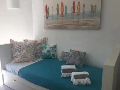 a bed in a room with a painting on the wall at Villa Zen - beautiful private pool-heating option, hot tub, beautiful garden in Albufeira