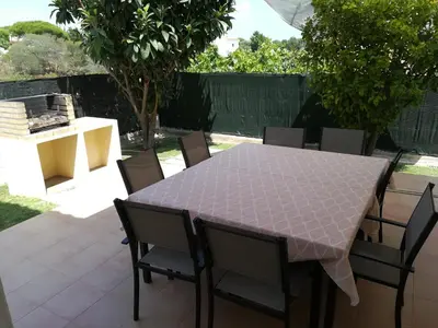 a table and chairs sitting on a patio at Villa 48 in Quarteira