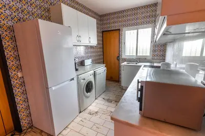 a kitchen with a refrigerator and a washing machine at Villa 300m from Beach - By Algarkasa in Albufeira