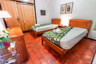 a room with two beds and a table with a lamp at Villa 300m from Beach - By Algarkasa in Albufeira