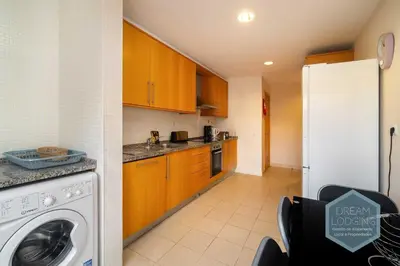 a room with a hallway with a bed and a table at Corcovada B42 - Dream Lodging in Albufeira