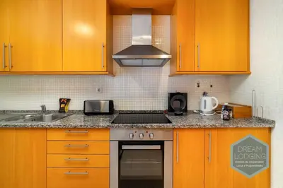 a kitchen with a washing machine and a refrigerator at Corcovada B42 - Dream Lodging in Albufeira