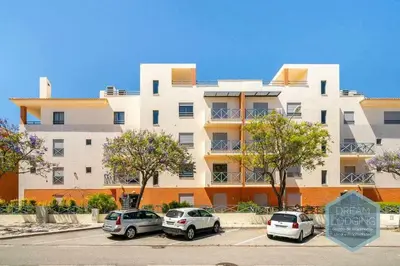 a building with three cars parked in a parking lot at Corcovada B42 - Dream Lodging in Albufeira