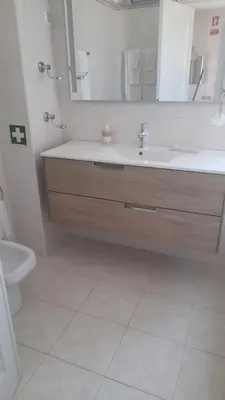 a bathroom with a sink and a toilet and a mirror at A Apartmento Solar dos Pinheiros in Vilamoura