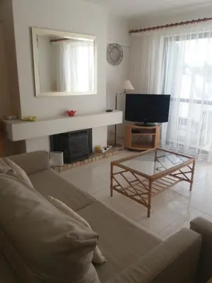 a living room with a couch and a tv at A Apartmento Solar dos Pinheiros in Vilamoura