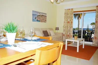 a dining room and living room with a dining table at Apartment Coelha Beach - Pool - Free Wi-Fi - Air Con in Albufeira