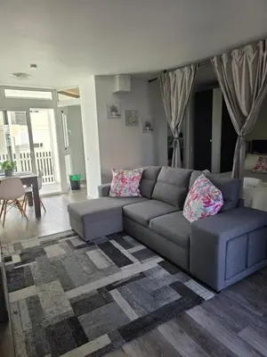 a living room with a gray couch and a table at Marina Vilamoura in Vilamoura