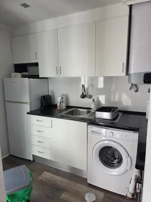 a kitchen with a washing machine and a sink at Marina Vilamoura in Vilamoura