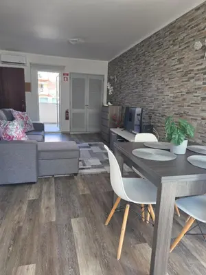 a living room with a couch and a table and chairs at Marina Vilamoura in Vilamoura