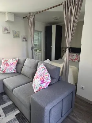a living room with a couch and a bed at Marina Vilamoura in Vilamoura