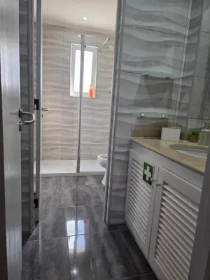 a bathroom with a shower and a toilet and a sink at Marina Vilamoura in Vilamoura