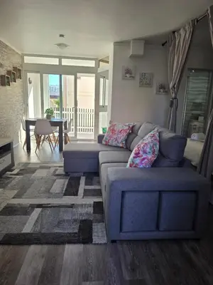 a living room with a couch and a table at Marina Vilamoura in Vilamoura
