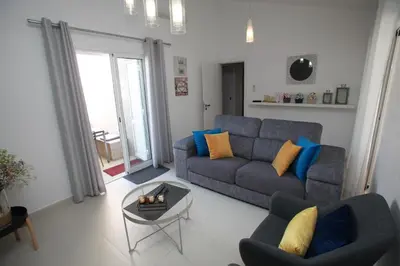 a living room with a couch and a table at Apartamento A Palmeira in Albufeira