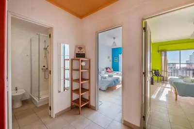 a bathroom with a shower and a bedroom at Vita Portucale ! Quarteira Sea View in Quarteira