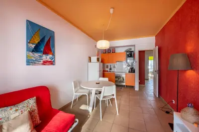 a living room with a red couch and a table at Vita Portucale ! Quarteira Sea View in Quarteira