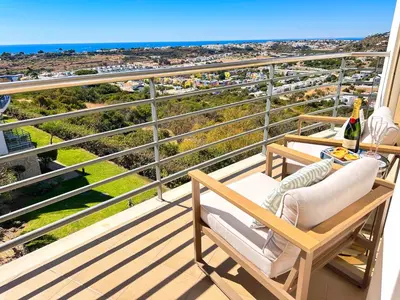 a balcony with a table and chairs and the ocean at AlbufeiraOrada by Be Cherish in Albufeira