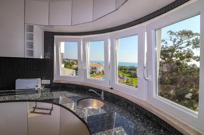 a kitchen with a sink and windows with a view at Santa Eulalia Mar in Albufeira
