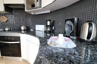 a kitchen with a counter top with a coffee maker at Santa Eulalia Mar in Albufeira