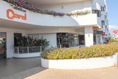 a shopping center with flowers in front of a building at Santa Eulalia Mar in Albufeira