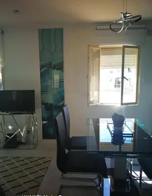 a dining room with a glass table and a chair at Atlântida T1 in Cavacos