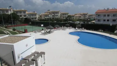 a large swimming pool with lounge chairs at Vista das Ondas in Albufeira