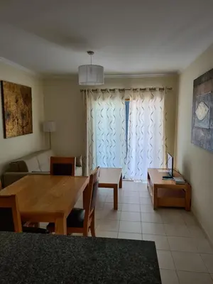 a living room with a wooden table and a couch at Vista das Ondas in Albufeira