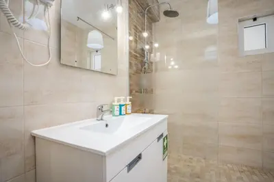 a bathroom with a white sink and a mirror at #002 Donalds Flat by Home Holidays in Albufeira