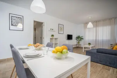 a white table with a bowl of fruit on it in a living room at #002 Donalds Flat by Home Holidays in Albufeira