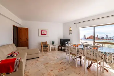 a living room with a couch and a table at Casa Cerro Branco in Albufeira