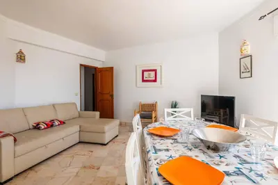 a living room with a couch and a table at Casa Cerro Branco in Albufeira