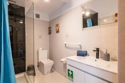 a bathroom with a toilet and a sink and a shower at Casa Cerro Branco in Albufeira