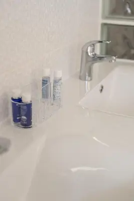 a bathroom sink with two bottles ofodorizers on it at Fisherman's Beach Home 2BR 2BA AC Wi-Fi in Albufeira